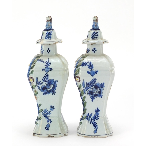 346 - **WITHDRAWN**Pair of Dutch Delft pottery vases and covers hand painted with village scenes, 21cm hig... 