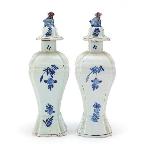 346 - **WITHDRAWN**Pair of Dutch Delft pottery vases and covers hand painted with village scenes, 21cm hig... 