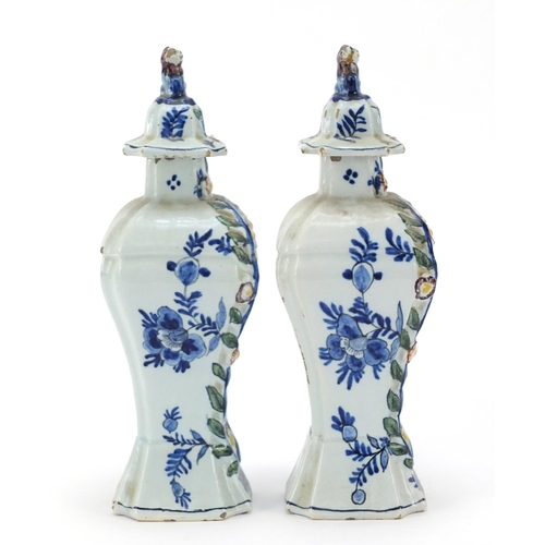 346 - **WITHDRAWN**Pair of Dutch Delft pottery vases and covers hand painted with village scenes, 21cm hig... 