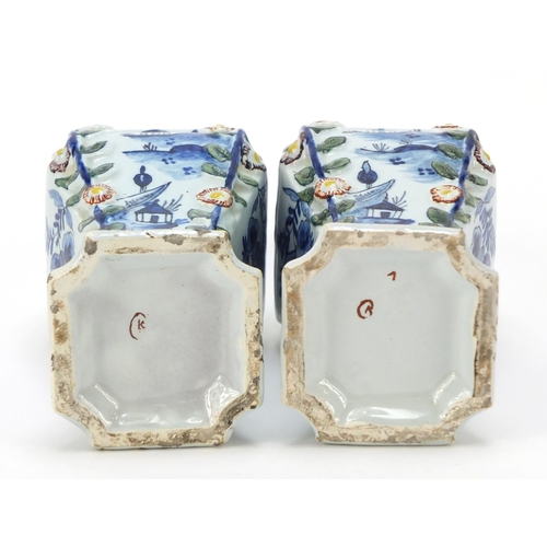 346 - **WITHDRAWN**Pair of Dutch Delft pottery vases and covers hand painted with village scenes, 21cm hig... 