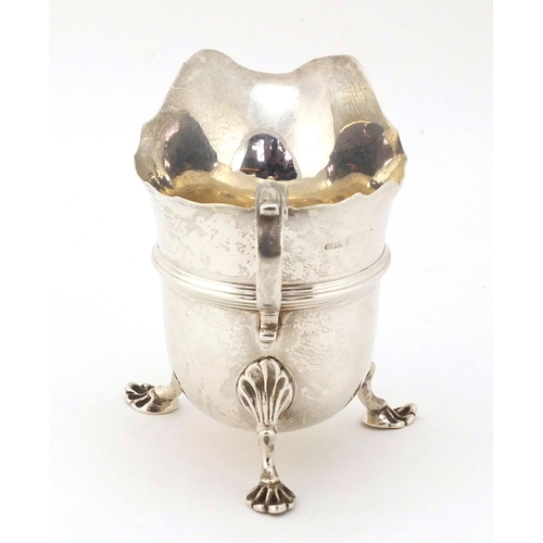 367 - Stokes & Ireland, Edwardian silver cream jug, raised on three pad feet, Chester 1903, 8cm high, 91g