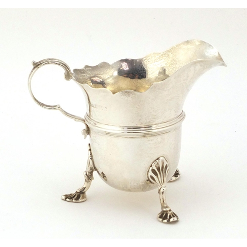 367 - Stokes & Ireland, Edwardian silver cream jug, raised on three pad feet, Chester 1903, 8cm high, 91g