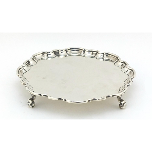 21 - Atkin Brothers, Georgian style silver salver raised on four scroll feet, Sheffield 1935, 20.5cm in d... 