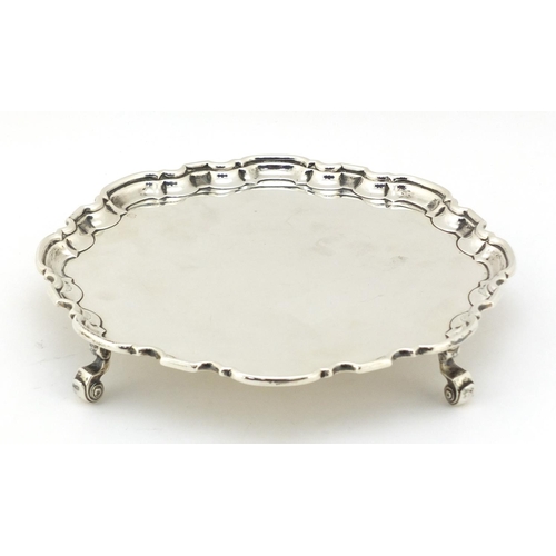 21 - Atkin Brothers, Georgian style silver salver raised on four scroll feet, Sheffield 1935, 20.5cm in d... 