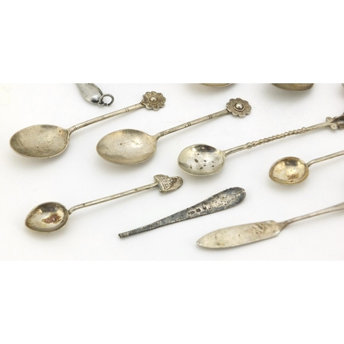 761 - Silver and white metal objects including two miniature photo frames, sugar tongs and teaspoons, vari... 