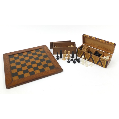 1980A - Three sets of wooden and composite chess pieces and a inlaid oak chess board, 43.5cm x 43.5cm