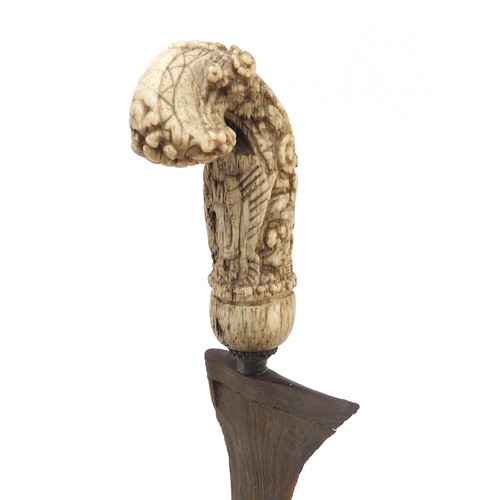 243 - Javanese Kris with carved bone handle and brass sheaf, 50cm in length