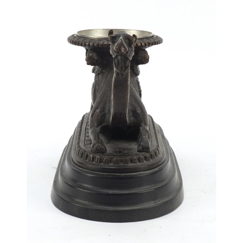 95 - Bronze model of a crouching camel raised on oval stepped base, 28cm in length