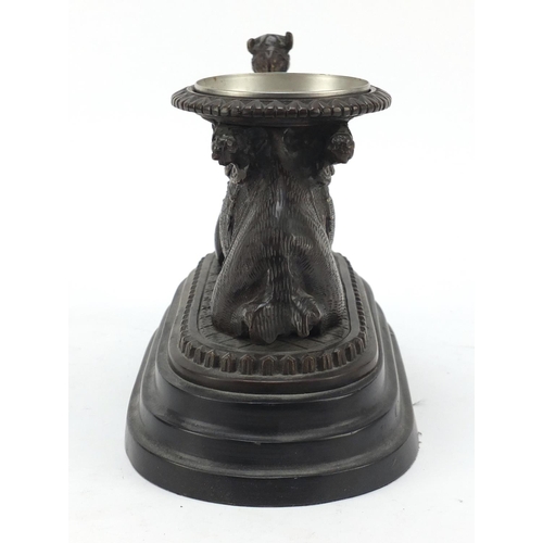 95 - Bronze model of a crouching camel raised on oval stepped base, 28cm in length