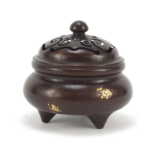 713 - Chinese gold splashed patinated bronze tripod incense burner with pierced lid, four figure character... 