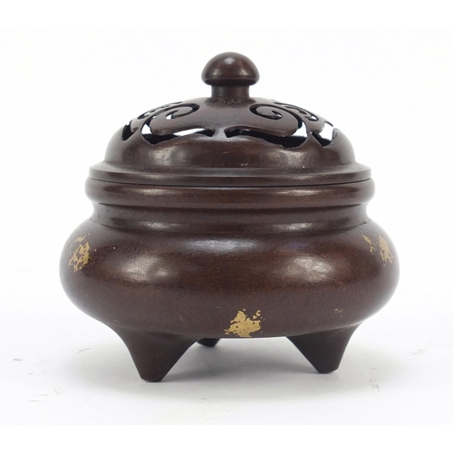 713 - Chinese gold splashed patinated bronze tripod incense burner with pierced lid, four figure character... 