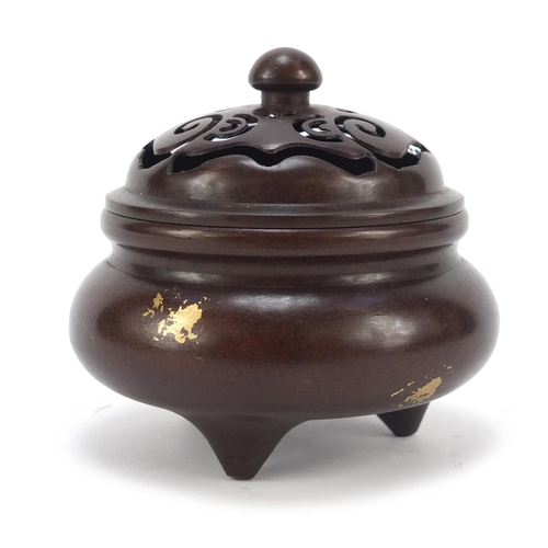 713 - Chinese gold splashed patinated bronze tripod incense burner with pierced lid, four figure character... 