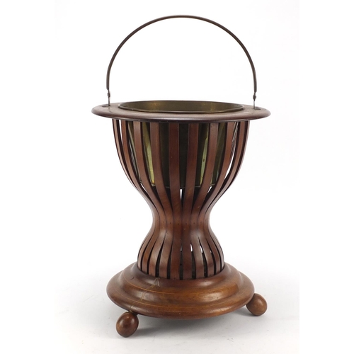 148 - Regency style inlaid mahogany ice bucket with brass liner and swing handle, 41cm high