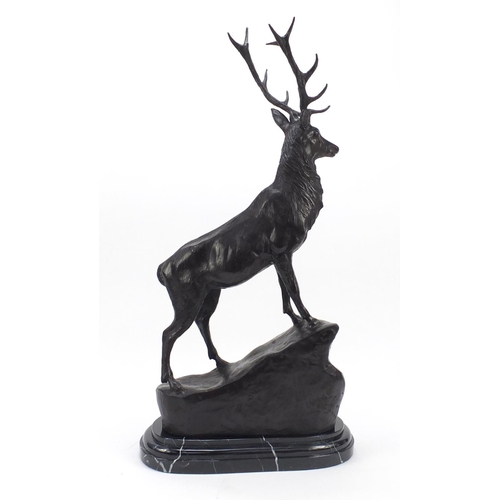 61 - Large patinated bronze stag raised on a stepped marble base, 74cm high