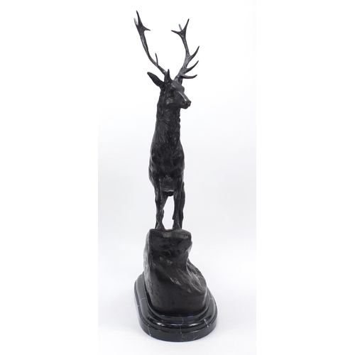 61 - Large patinated bronze stag raised on a stepped marble base, 74cm high