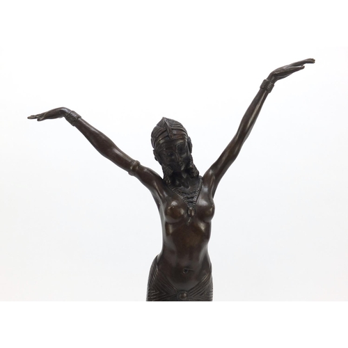 194 - Large patinated bronze figure of a scantily dressed Art Deco female raised on a tapering marble base... 