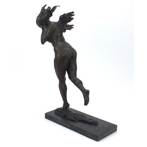 149 - Large surreal patinated bronze of a nude female raised on a green marbleised base, 61cm high