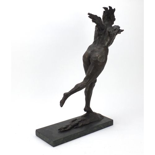 149 - Large surreal patinated bronze of a nude female raised on a green marbleised base, 61cm high