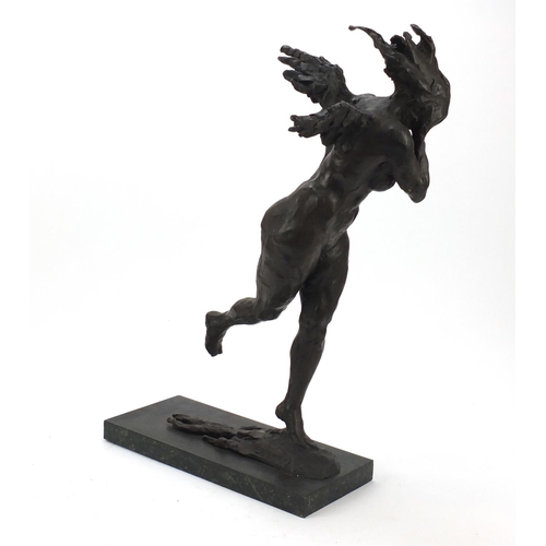 149 - Large surreal patinated bronze of a nude female raised on a green marbleised base, 61cm high