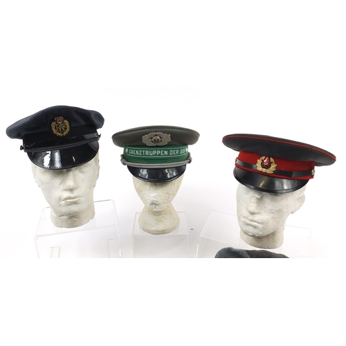 697 - Military interest hats/helmets including RAF, tin Warden and Russian peaked caps