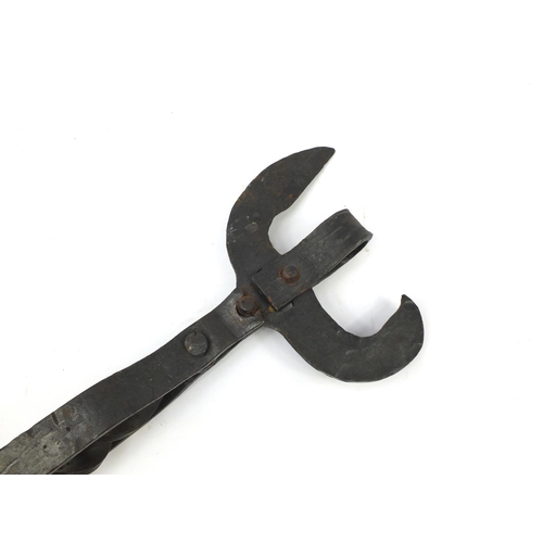 386 - Oversized cast iron can opener, possibly American, 65cm in length