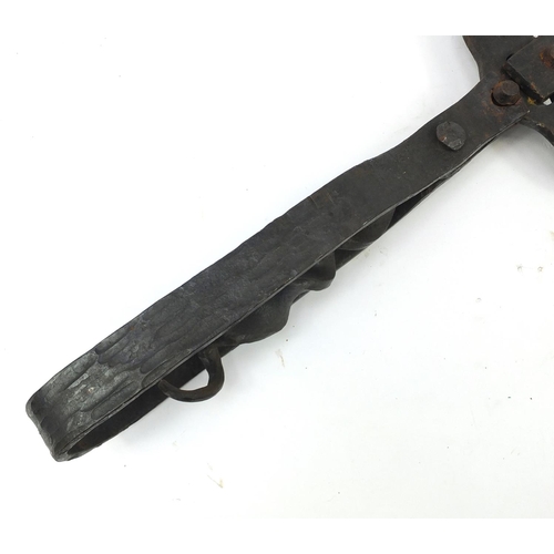 386 - Oversized cast iron can opener, possibly American, 65cm in length