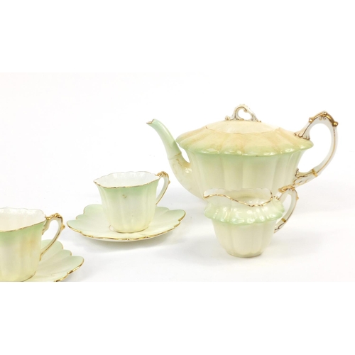 183 - Wileman Foley teaware comprising a teapot and four cups with saucers, the teapot 23cm in length