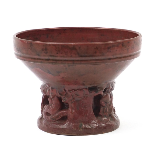 1169 - Art Deco style red glazed pottery Adam and Eve centrepiece, 19cm high x 26cm in diameter
