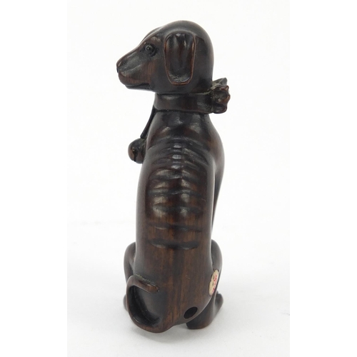 447 - Japanese boxwood Netsuke of a seated dog with character marks, 6.2cm high