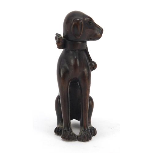 447 - Japanese boxwood Netsuke of a seated dog with character marks, 6.2cm high