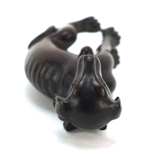 447 - Japanese boxwood Netsuke of a seated dog with character marks, 6.2cm high