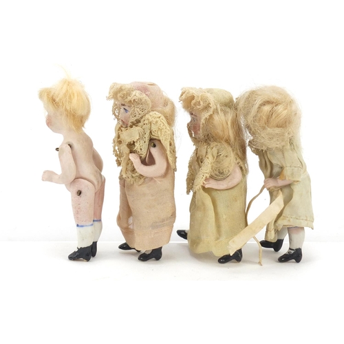 750 - Four miniature bisque dolls with jointed limbs, each 7.5cm high