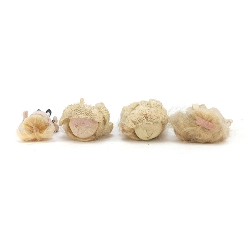 750 - Four miniature bisque dolls with jointed limbs, each 7.5cm high