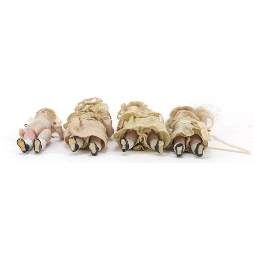 750 - Four miniature bisque dolls with jointed limbs, each 7.5cm high