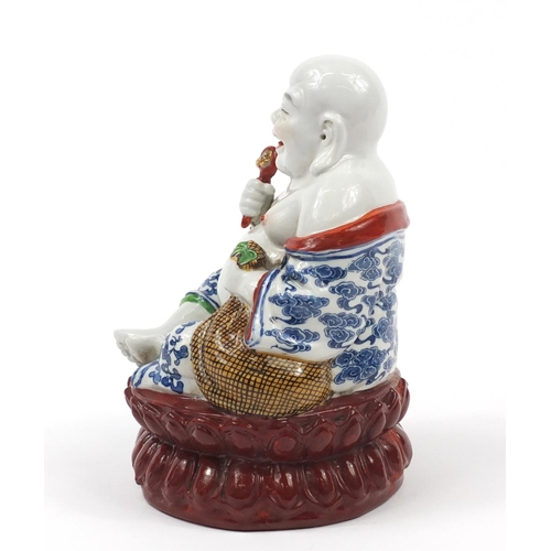 2015 - Chinese porcelain figure of seated Buddha, impressed character marks to the base, 21cm high