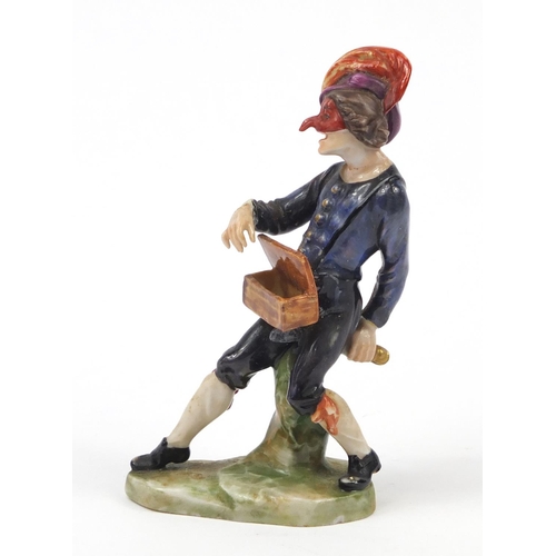 743 - 19th century Continental porcelain figure of an entertainer, factory marks to the base, 11.5cm high