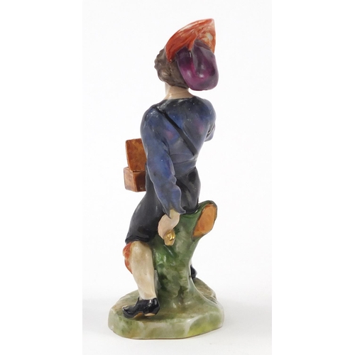 743 - 19th century Continental porcelain figure of an entertainer, factory marks to the base, 11.5cm high