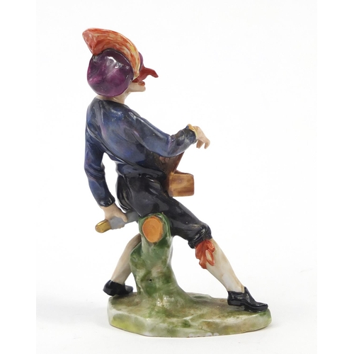 743 - 19th century Continental porcelain figure of an entertainer, factory marks to the base, 11.5cm high