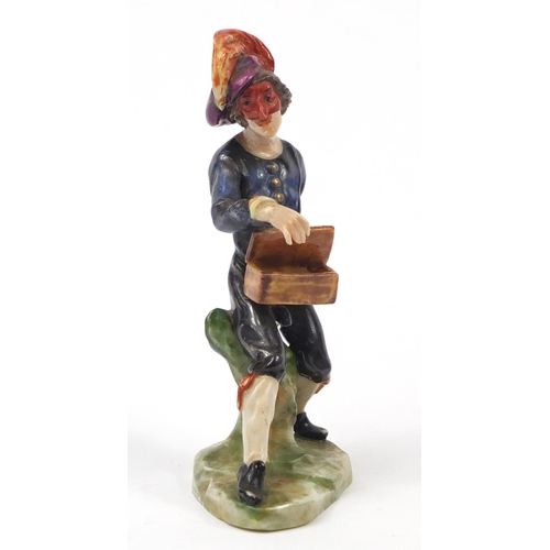 743 - 19th century Continental porcelain figure of an entertainer, factory marks to the base, 11.5cm high