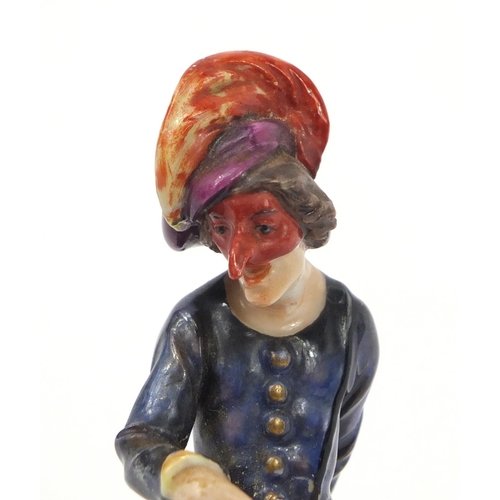 743 - 19th century Continental porcelain figure of an entertainer, factory marks to the base, 11.5cm high