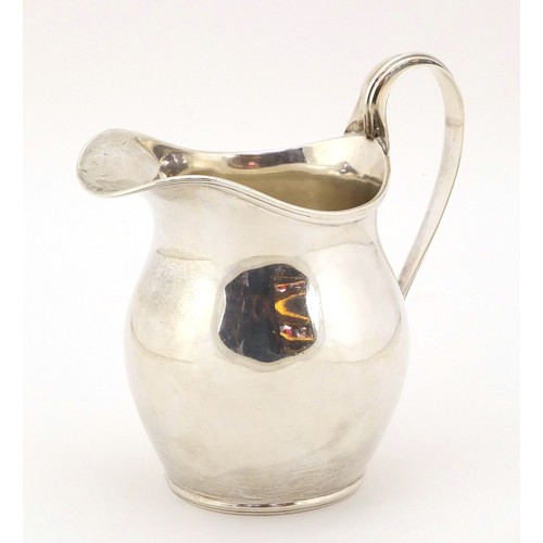 135 - William Aitken, Edwardian silver cream jug, Birmingham 1902, 10cm high, 165g