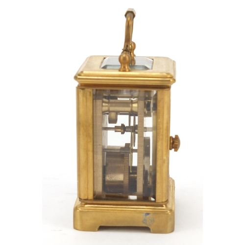 409 - Miniature gilt brass cased carriage clock with Roman and Arabic numerals, 6cm high