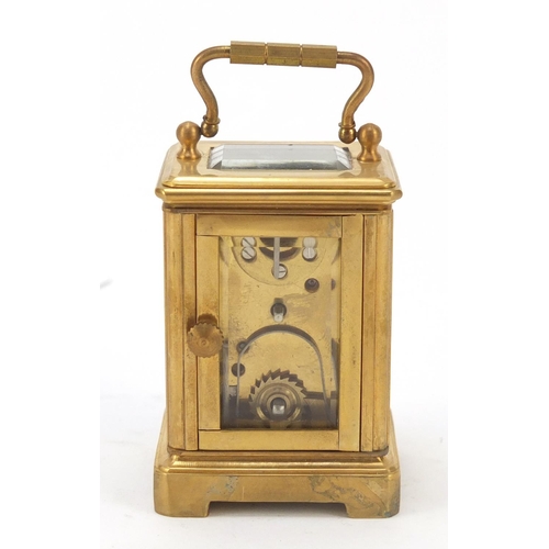 409 - Miniature gilt brass cased carriage clock with Roman and Arabic numerals, 6cm high