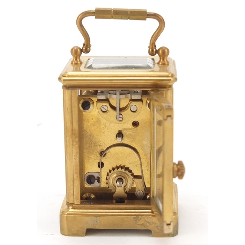 409 - Miniature gilt brass cased carriage clock with Roman and Arabic numerals, 6cm high