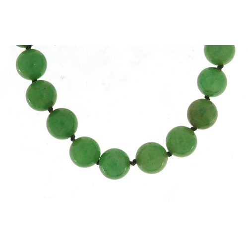 584 - Chinese green jade bead necklace, 84cm in length