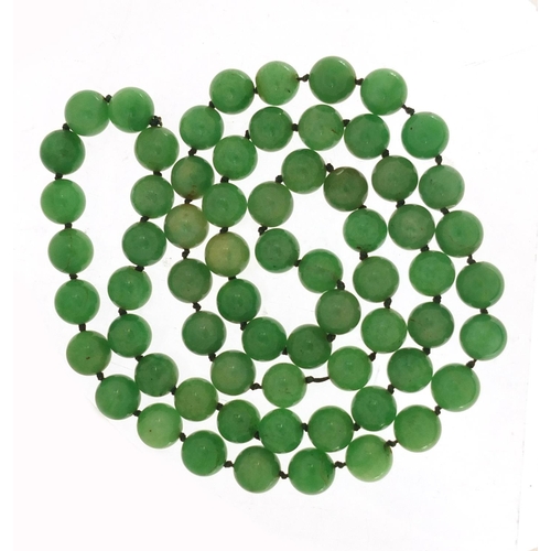 584 - Chinese green jade bead necklace, 84cm in length