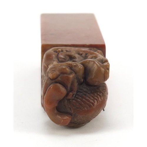 587 - Chinese soapstone seal carved with a dragon, character marks to the base, 12cm high