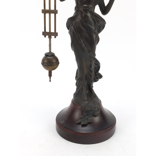 193 - Patinated bronzed mystery clock in the form of an Art Nouveau female, 33.5cm high