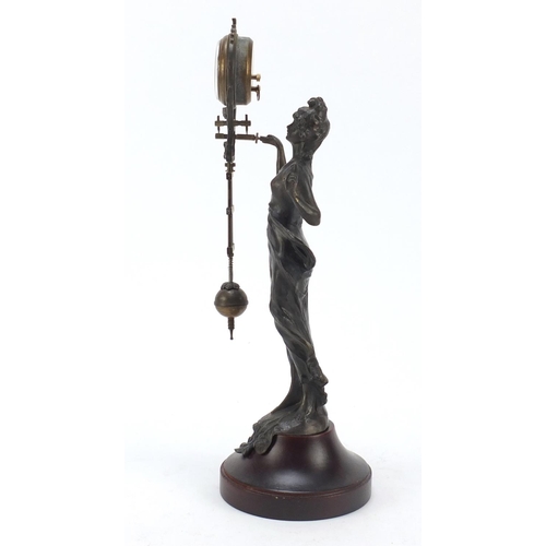 193 - Patinated bronzed mystery clock in the form of an Art Nouveau female, 33.5cm high