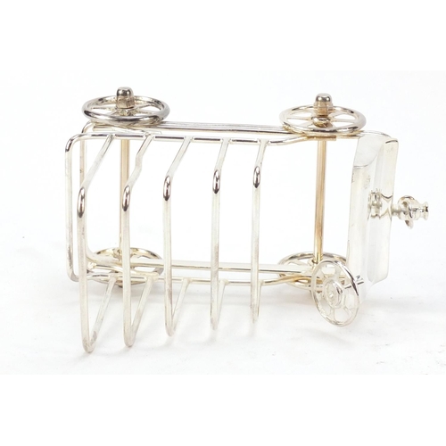 271 - Novelty silver plated toast rack in the form of a car with rotating wheels, 17cm in length